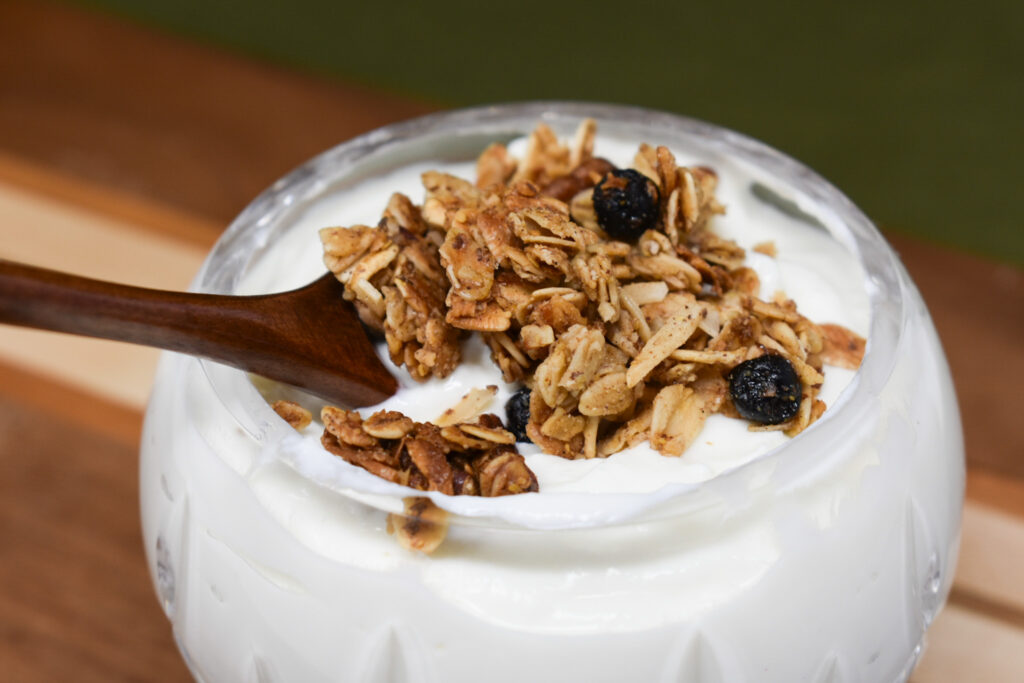 yogurt and granola on wooden board