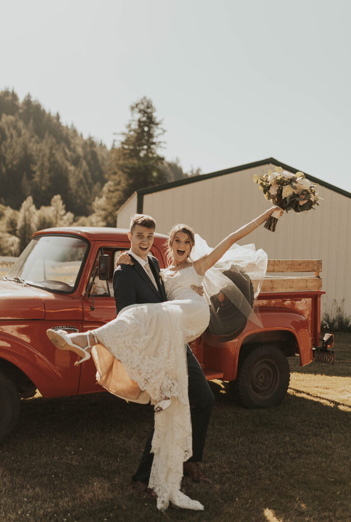 bride and groom in front of red truck