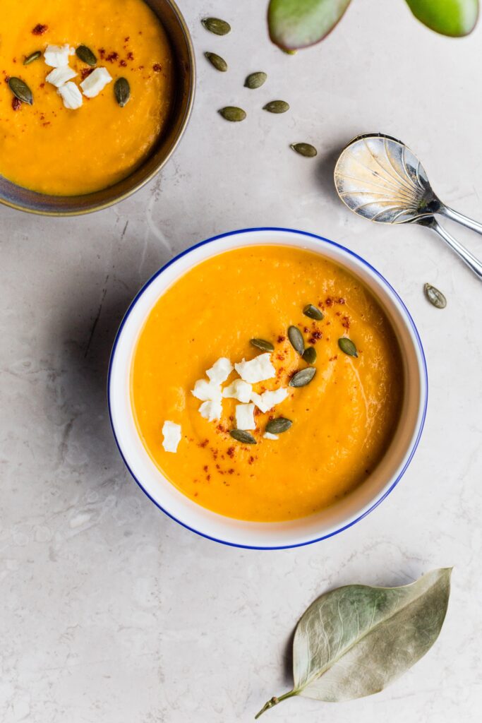 butternut squash soup in bowl on gray countertop