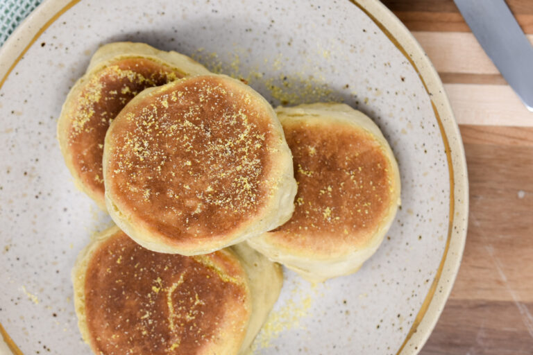 4 english muffins stacked on plate